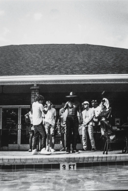 a group of people standing in front of a water fountain