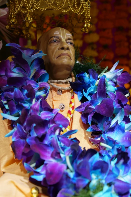 the statue is set up in purple flowers