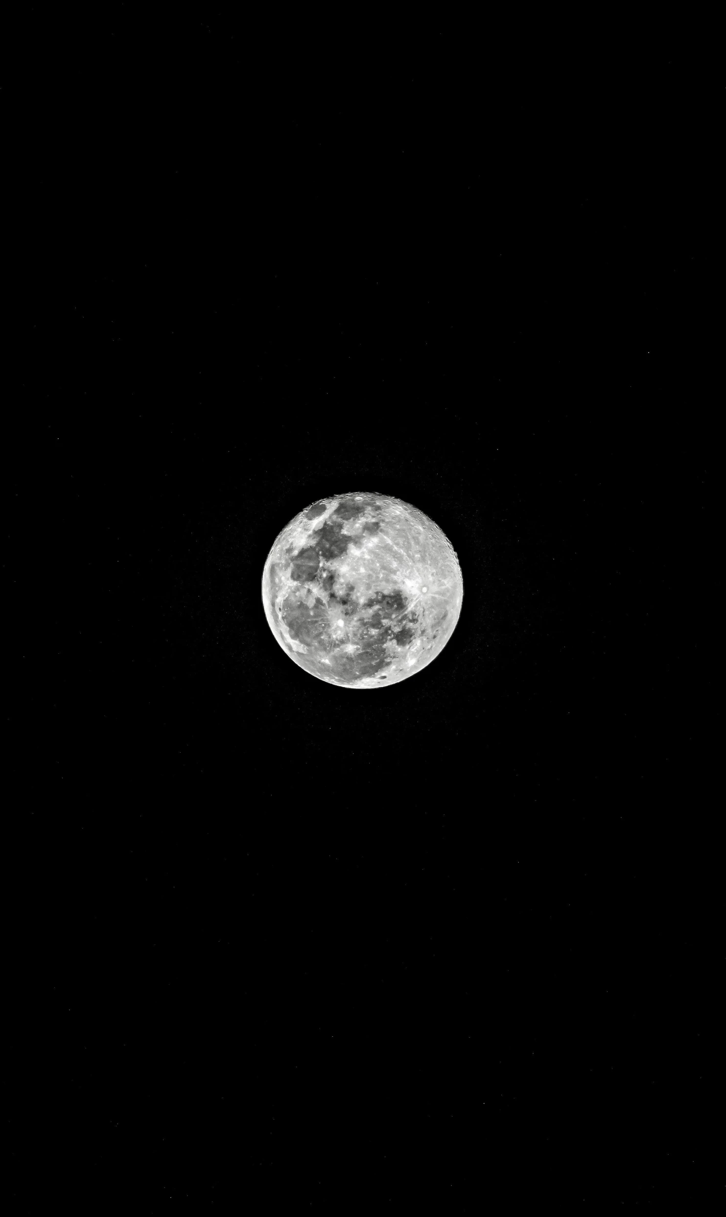 a dark background with the moon as a backdrop