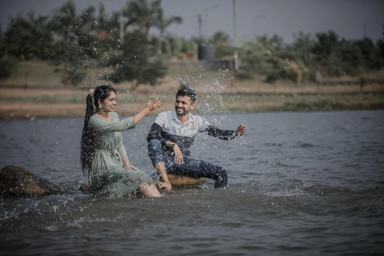 there is a man and a woman who are sitting in water