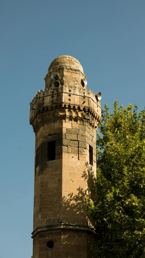 a very tall brick tower with a clock on top