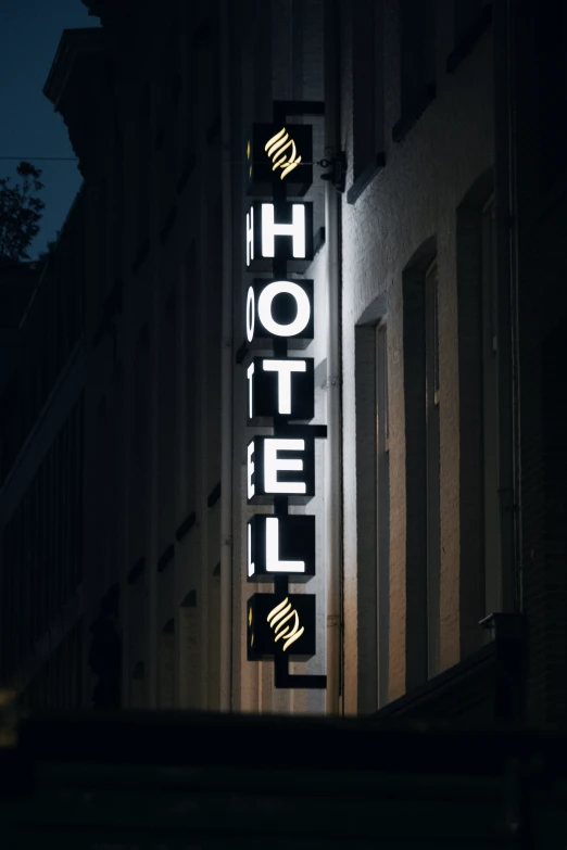 the el sign lit up at night in front of a building