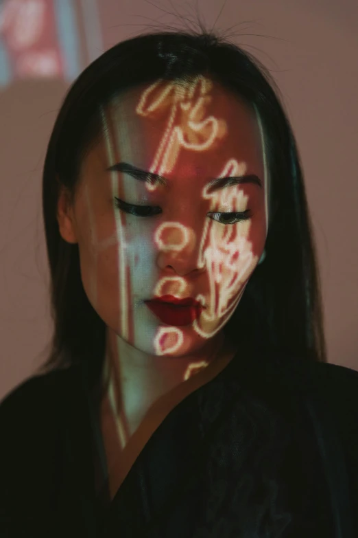 a woman is shown with illuminated images on her face