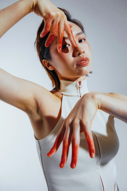 woman with red paint on her hands and head