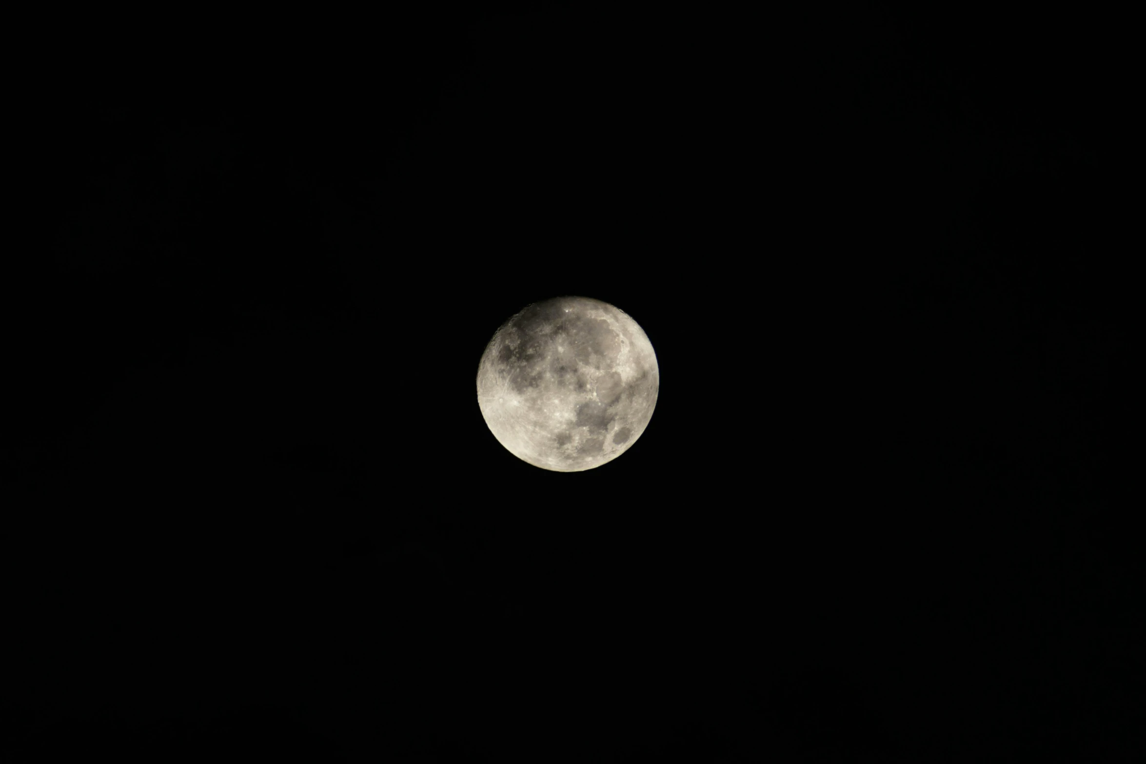 a view of the moon in the dark sky