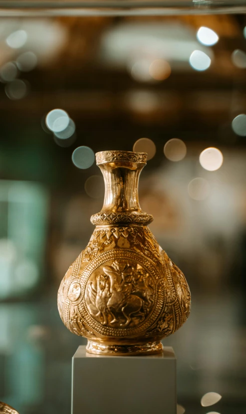 there is a ornate vase on display at the museum