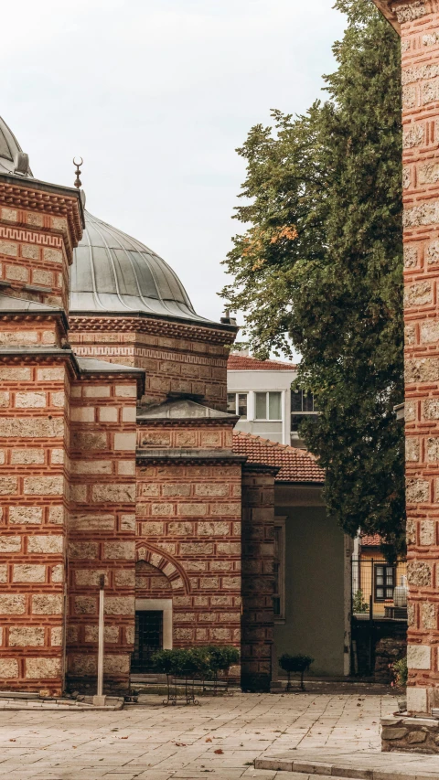 a large round brick building with a clock on it's side