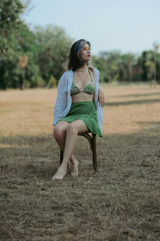 a woman sitting in a chair and wearing lingerie