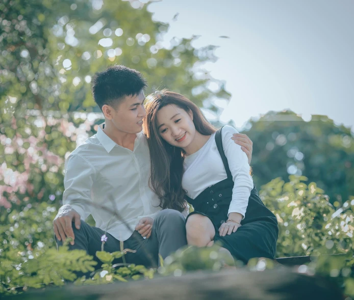 an engaged couple smile and hug each other