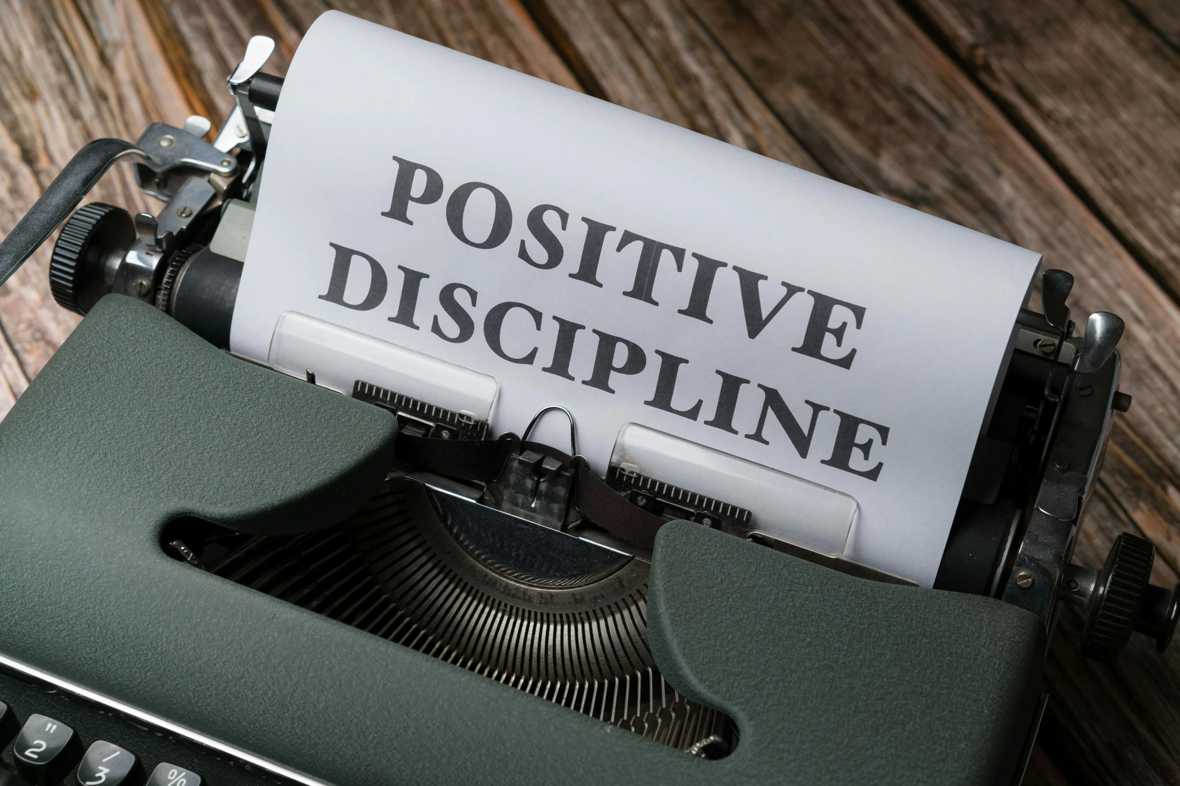 an old fashioned typewriter with the words positive, descriptive on paper