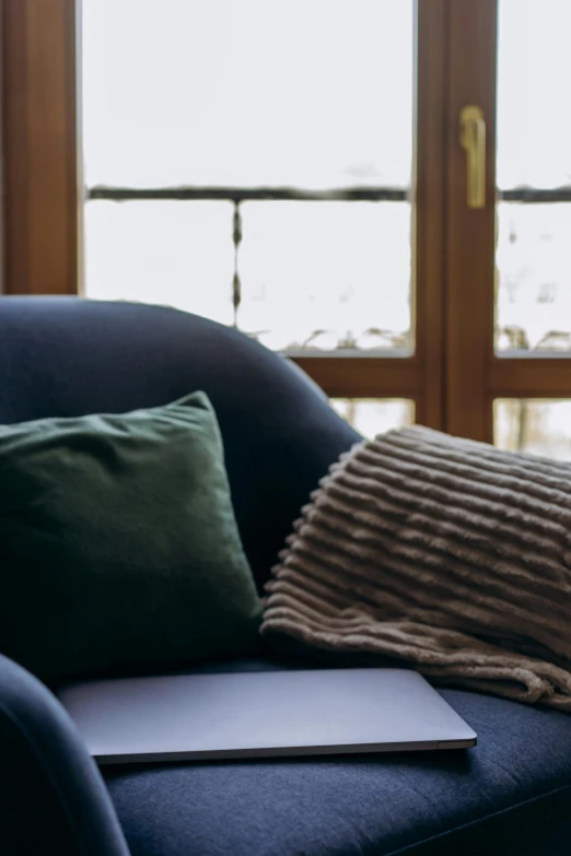 the blanket is dd around the cushion on the blue couch