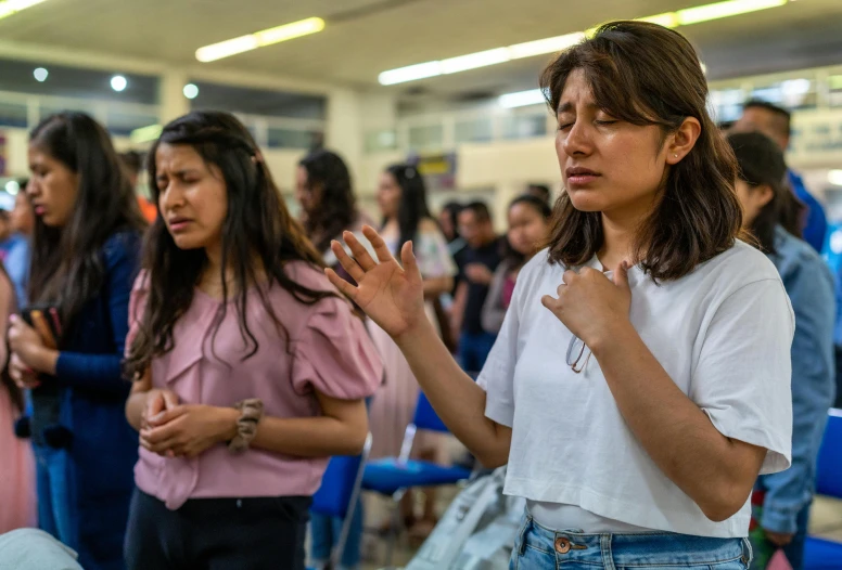 several people are standing in a long line with their hands crossed