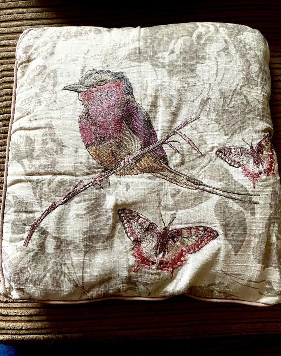 the pillow case is made out of old t - shirt material with bird
