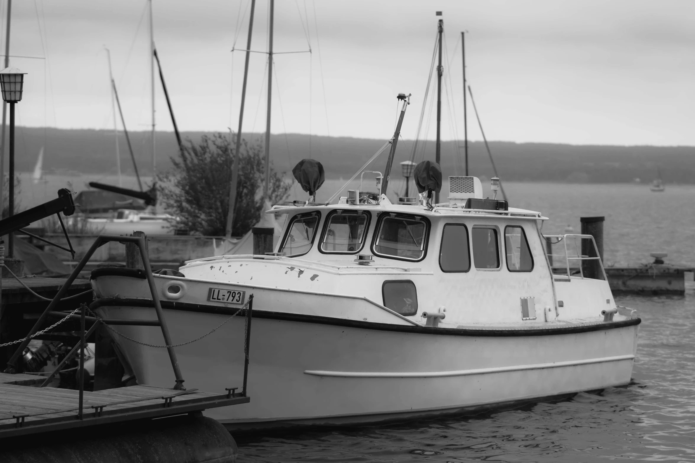 a boat docked with a bunch of boats behind it