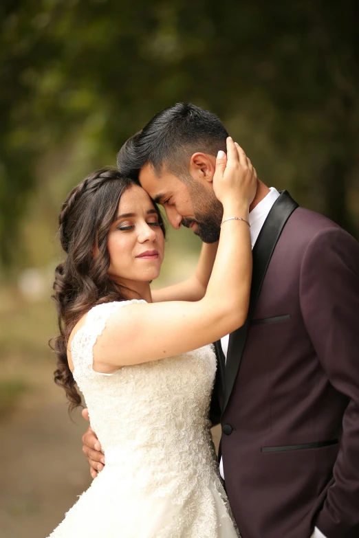 a bride hugging her groom as he gets ready to walk down the aisle