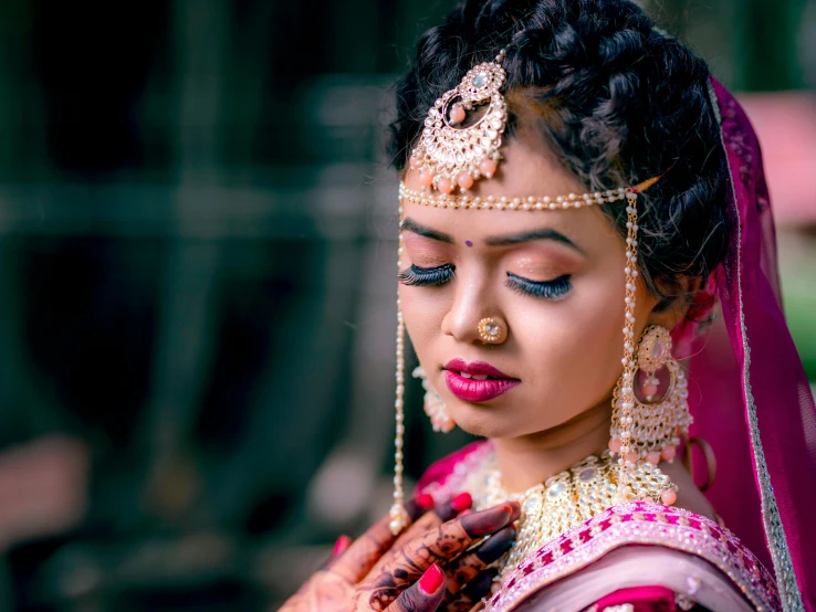a woman dressed in traditional indian wedding attire
