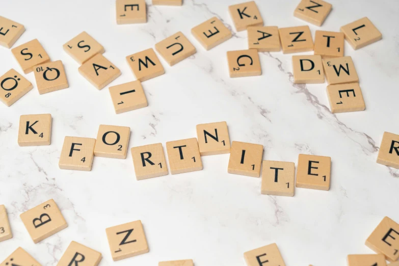 scrabble tiles are arranged over the letters on a marble counter