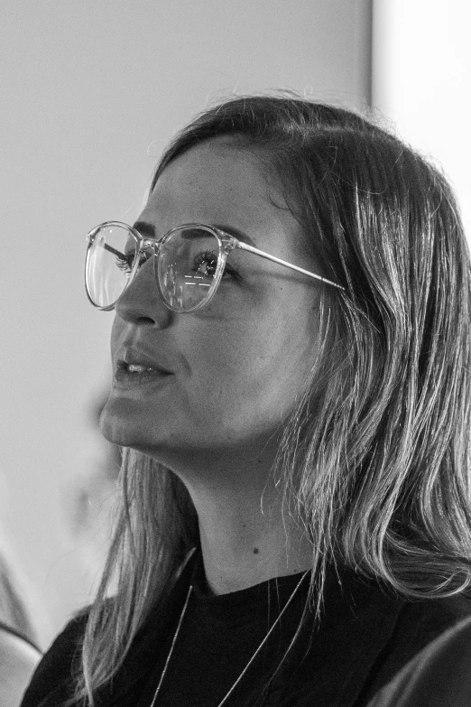 a black and white po of a woman wearing glasses