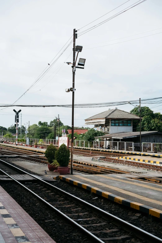 the empty railroad tracks are set up to allow passengers to sit on the platform