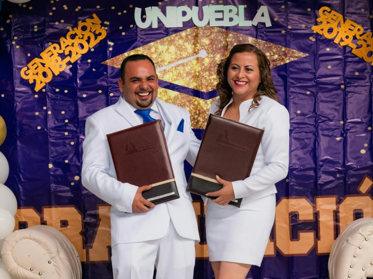 two people in a lab suits holding books