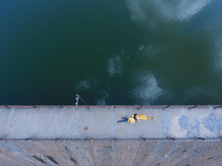 a person walking near some water and a bunch of bananas