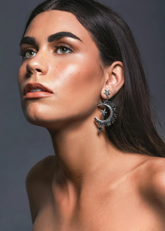 a beautiful woman with a pair of diamond earrings