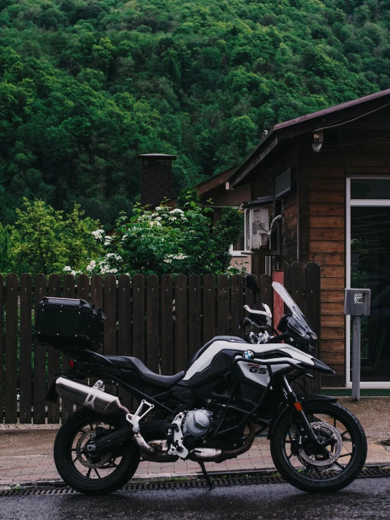 a motorcycle parked in front of a wood cabin