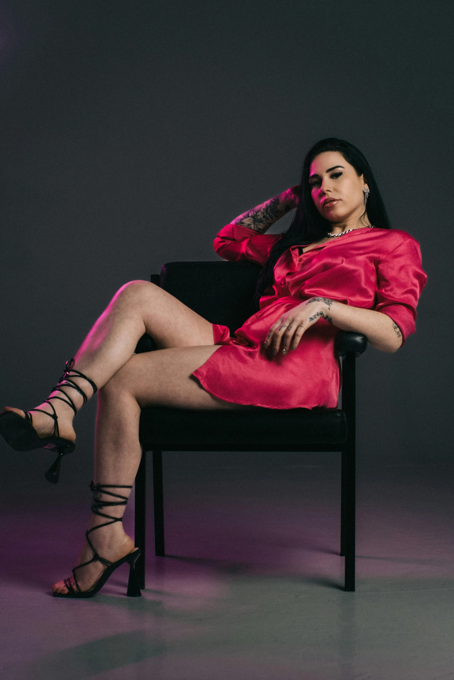 a woman wearing red is sitting in a chair