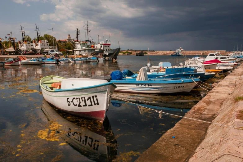 boats in the water next to an old dock