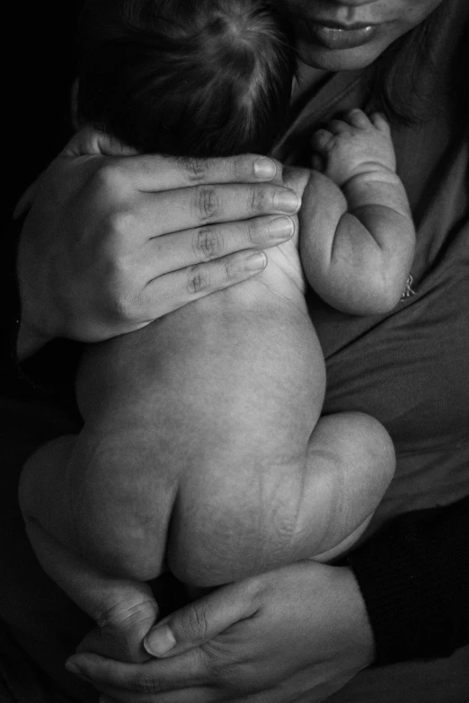 a woman holding a baby in her arms