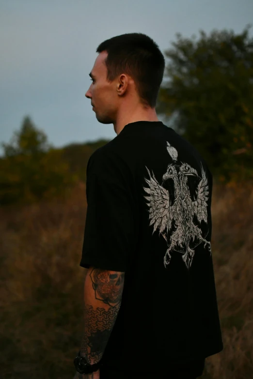 a man with tattoos wearing a black shirt