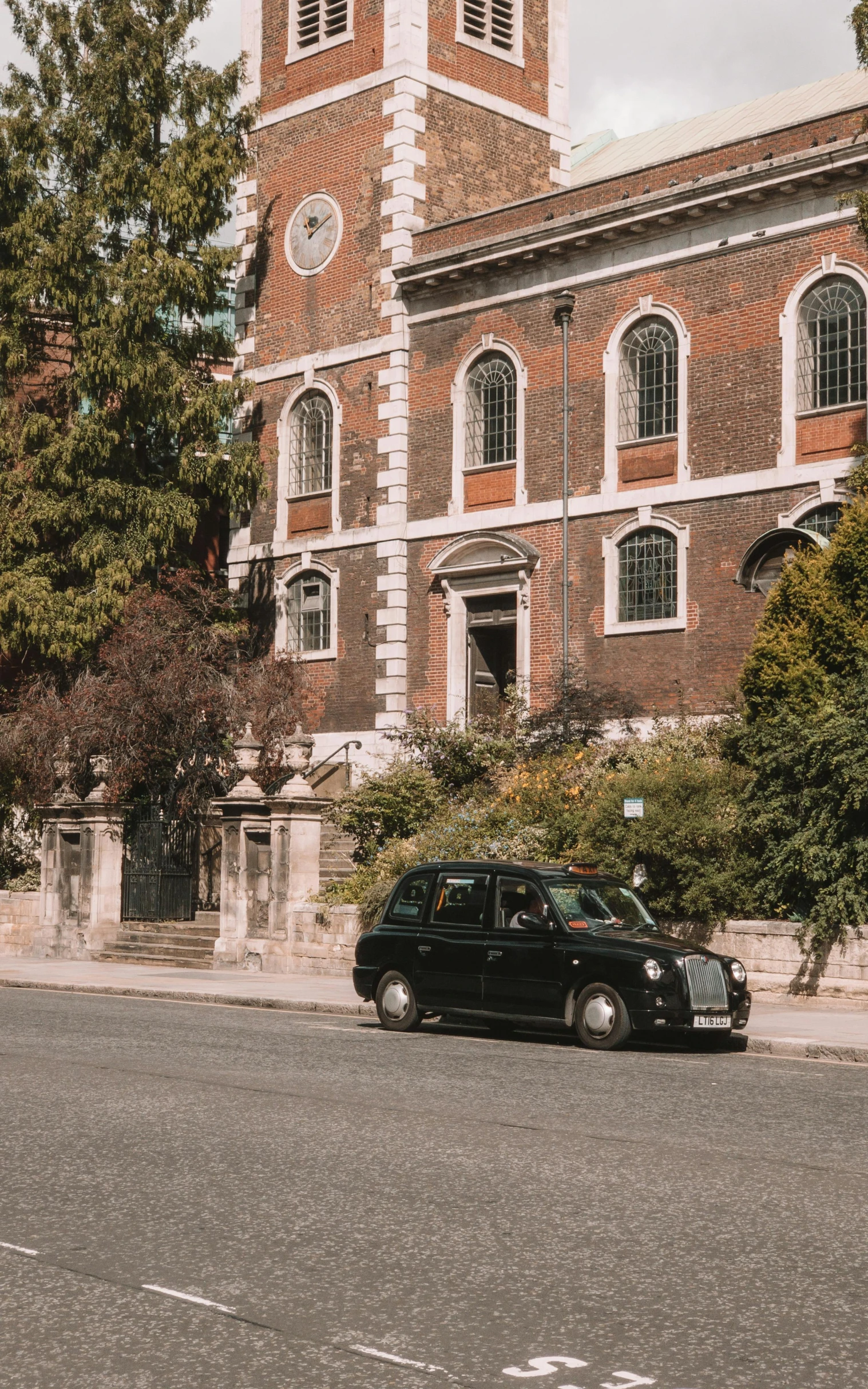 a small car parked in front of an old church