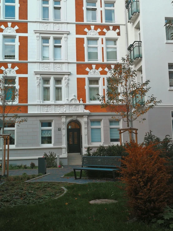 the facade of a red, white and orange building