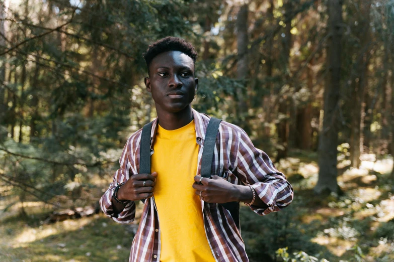 a young man with blue paint all over his face in the woods