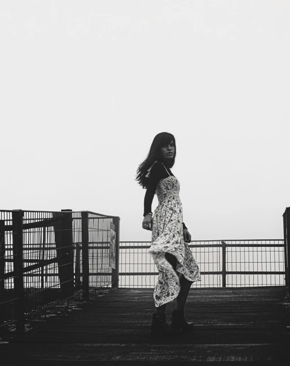 a girl stands at the top of some stairs