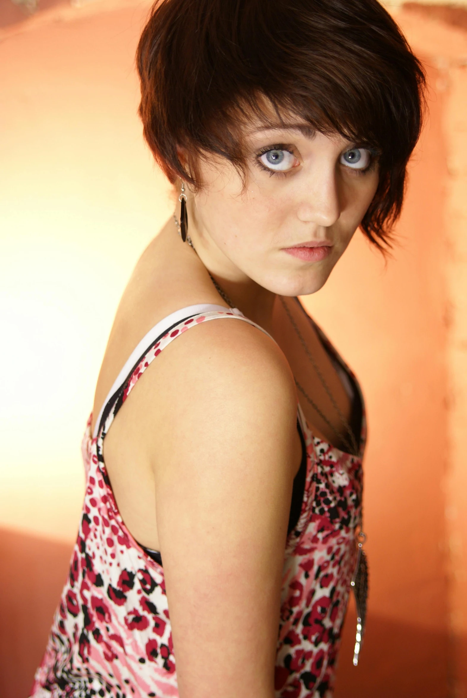 a young woman with short hair posing for a picture