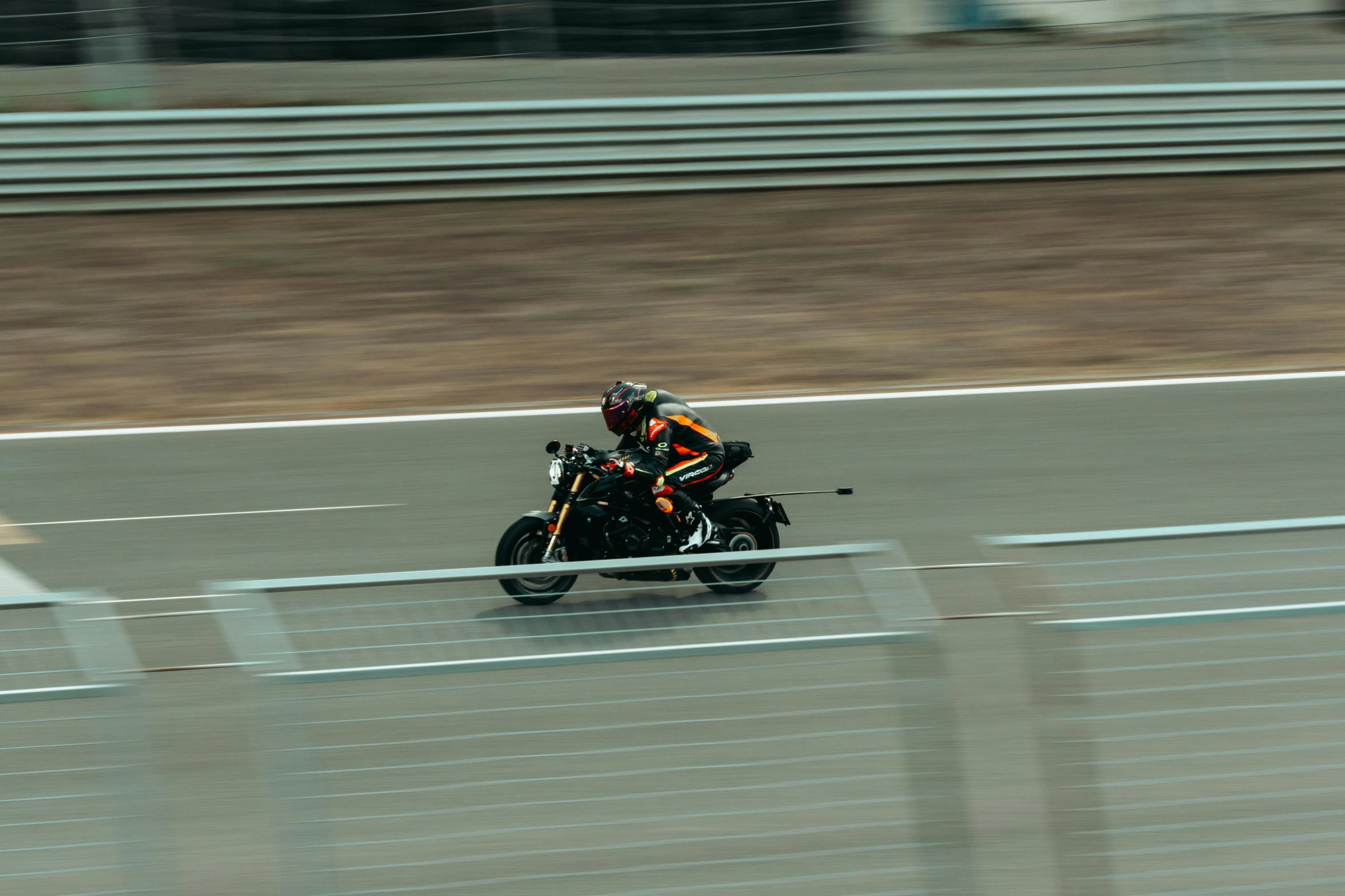 a motorcycle racing on the highway, going around a corner