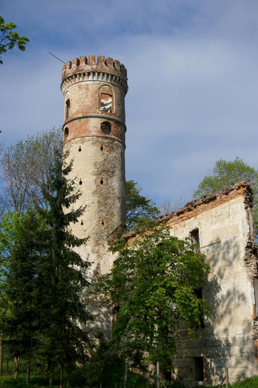 a very tall clock tower with trees near by