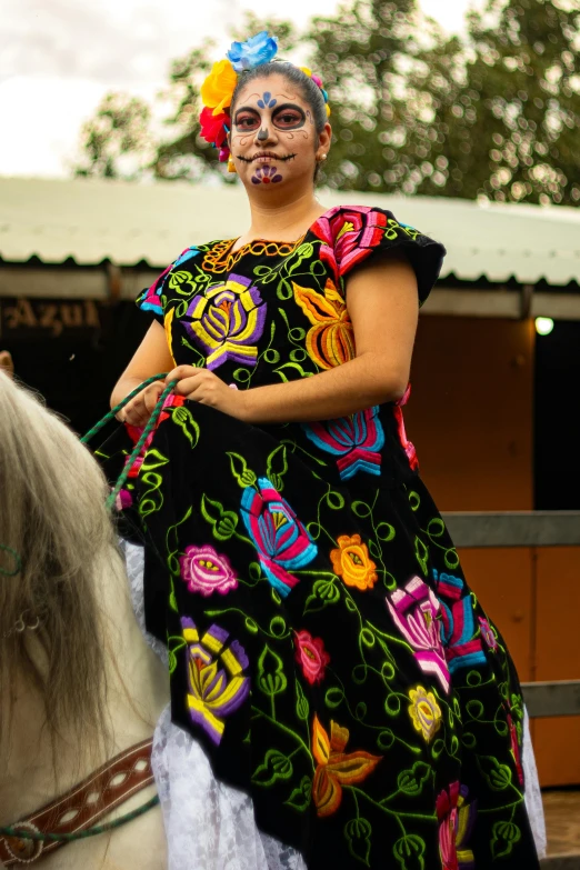 a lady with facial makeup riding a horse