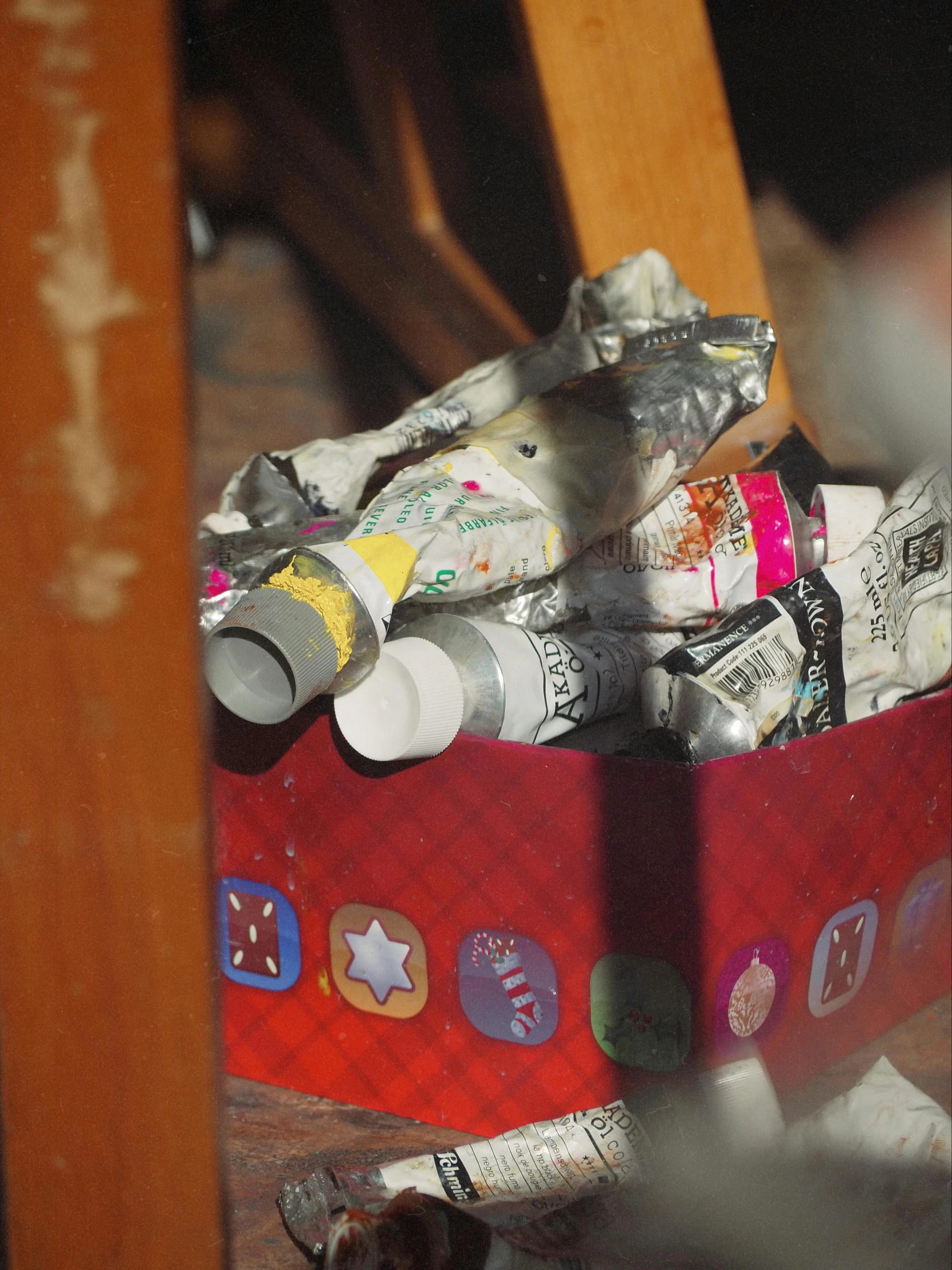 the bottom of a red basket filled with various soda bottles