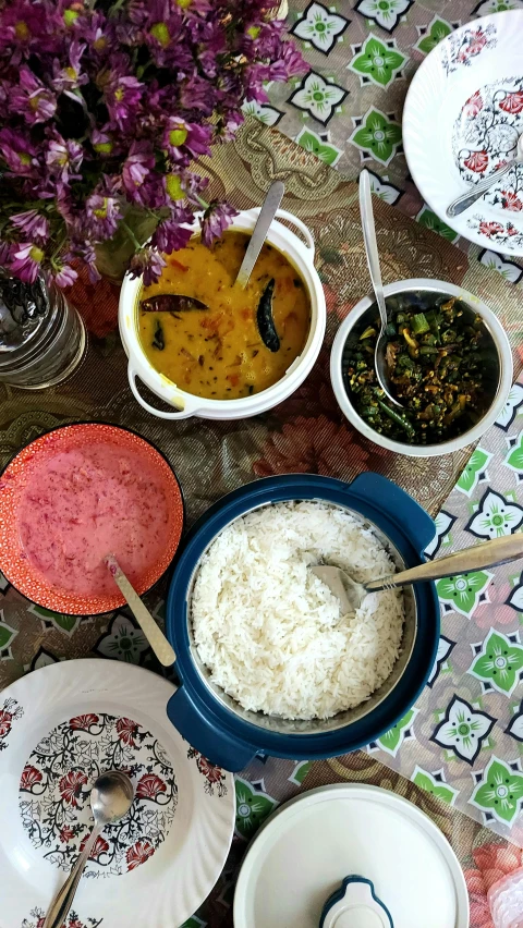 the table is filled with various bowls of food