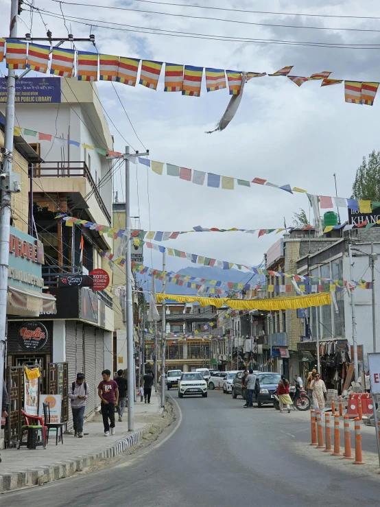 there are many cars parked on the street and people are walking through