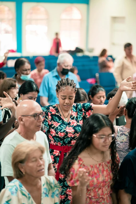 a group of people in chairs sitting down with their hands up