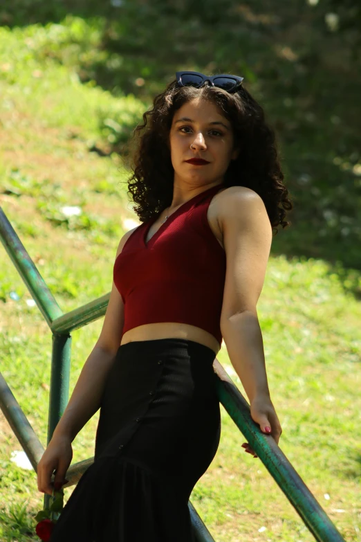 woman in black and red top posing near steps