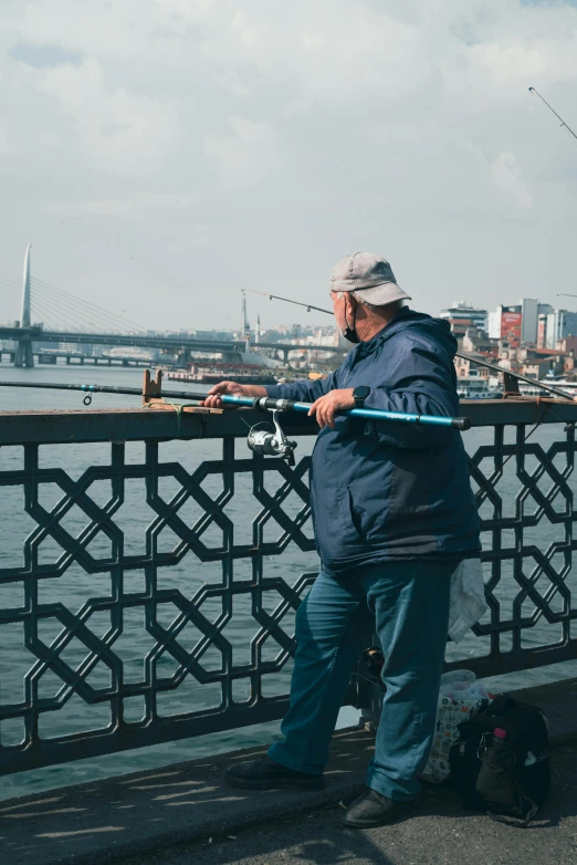 a man is fishing by the side of the water