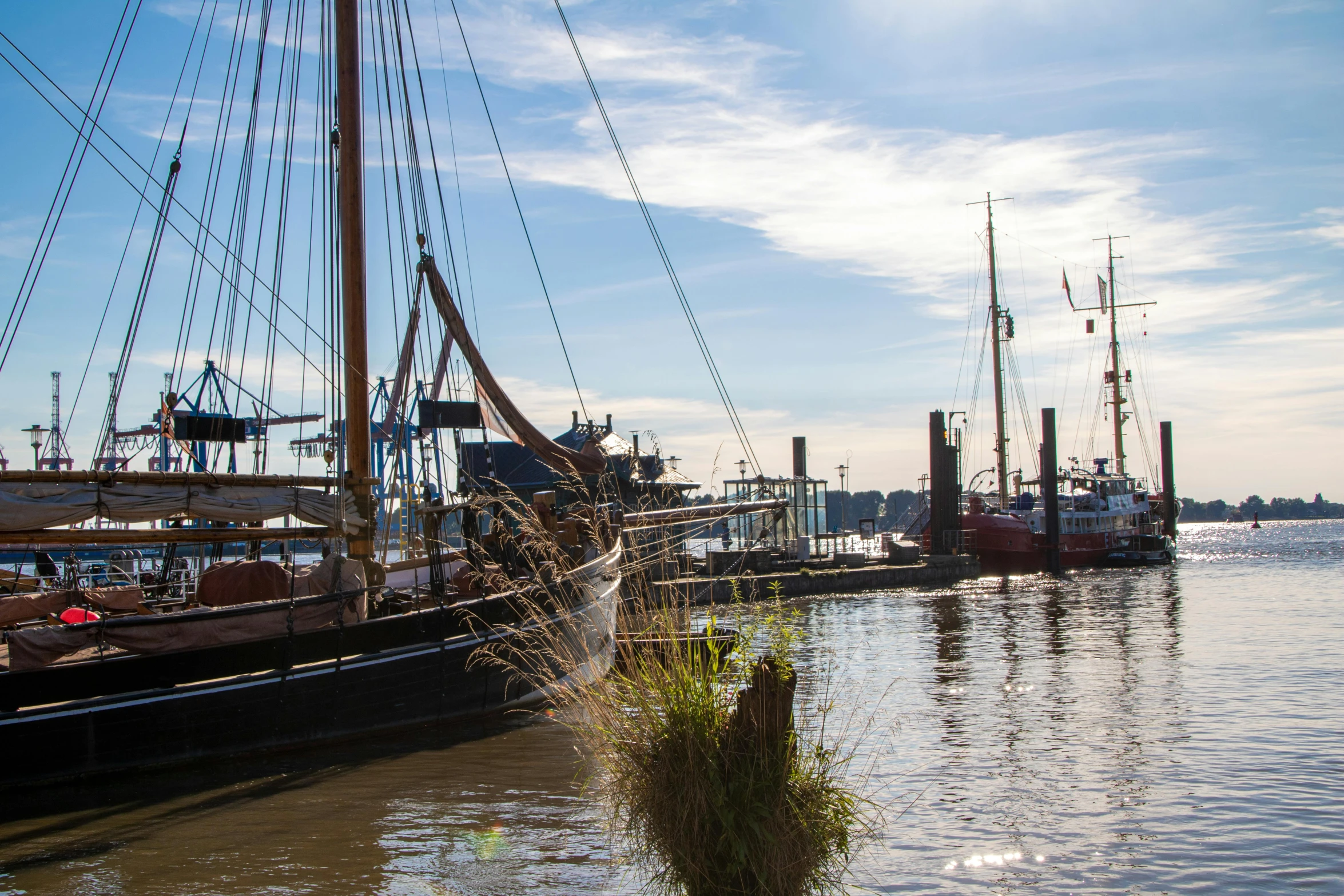 an old boat moored to the dock with other small boats