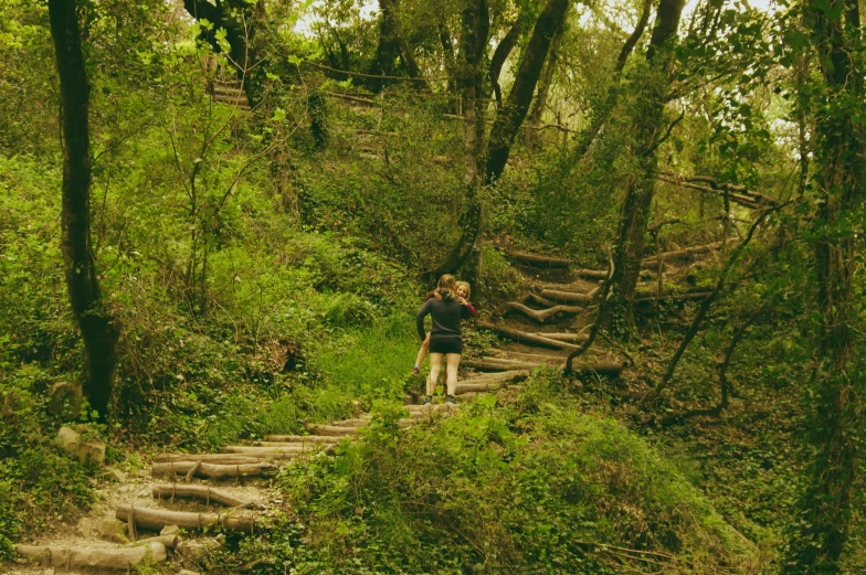 a woman on a hiking trail with stairs