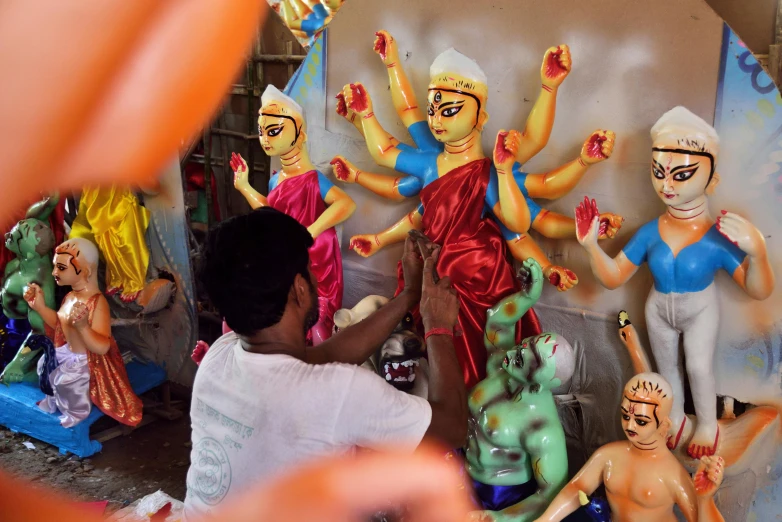 a group of people standing next to various statues