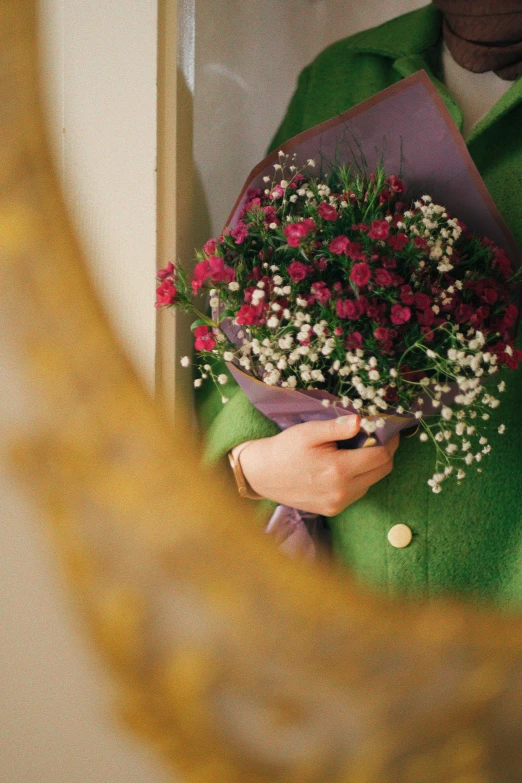 the person is holding a bouquet of flowers