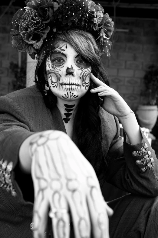 a lady with skeleton face paint poses for a picture